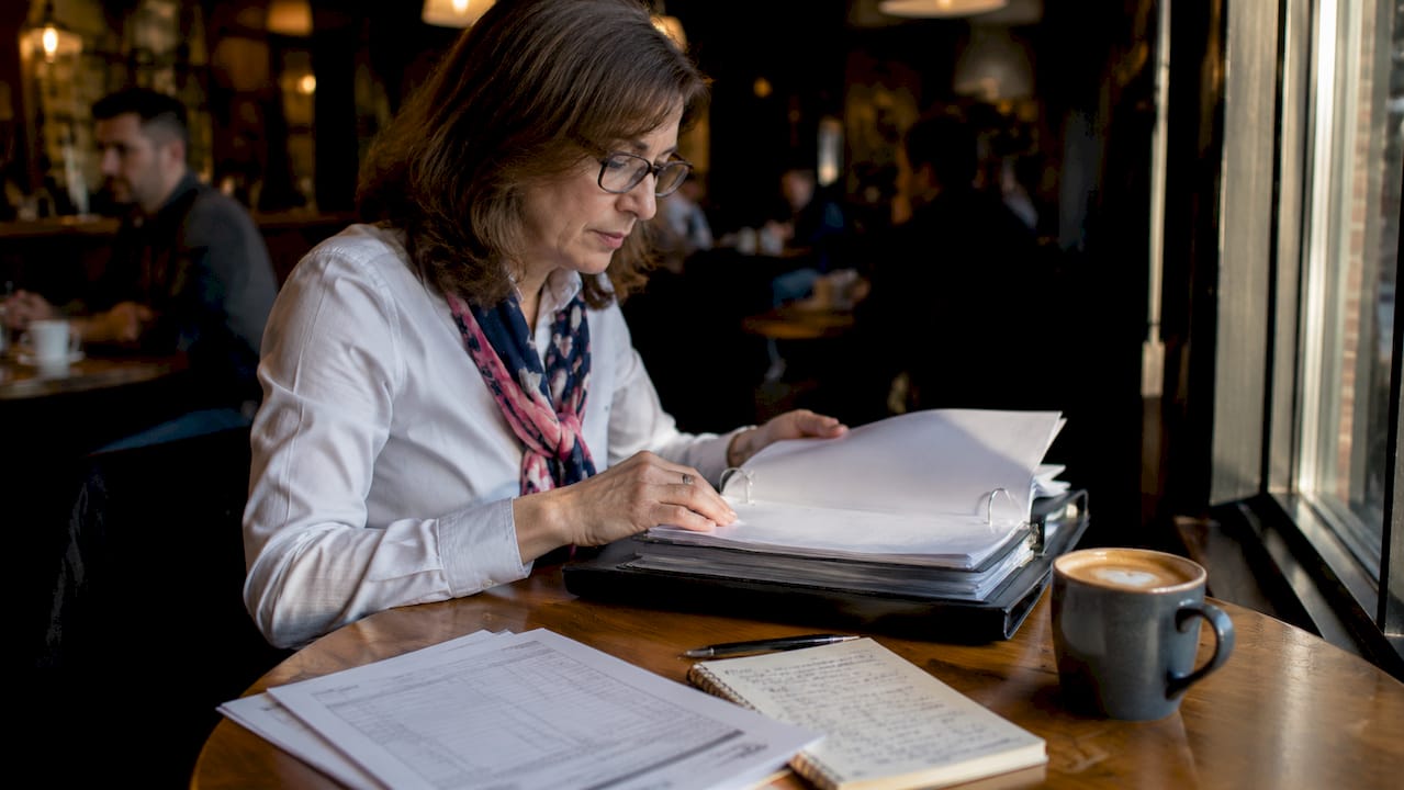 Woman reviewing vehicle maintenance documents