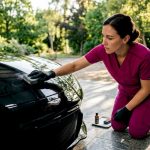 Technician applying ceramic coating on luxury car